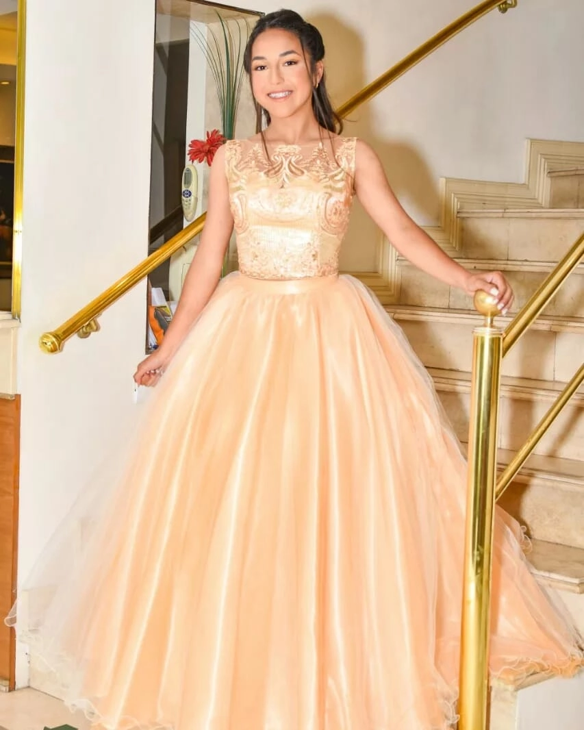 Quinceañera con vestido champagne de falda amplia